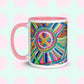 Discover the Geometric Rainbow Mug from My Favourite Colour is Rainbow, featuring a vibrant abstract design of colorful concentric circles and geometric patterns on a pale teal background, complete with a pink handle and interior.