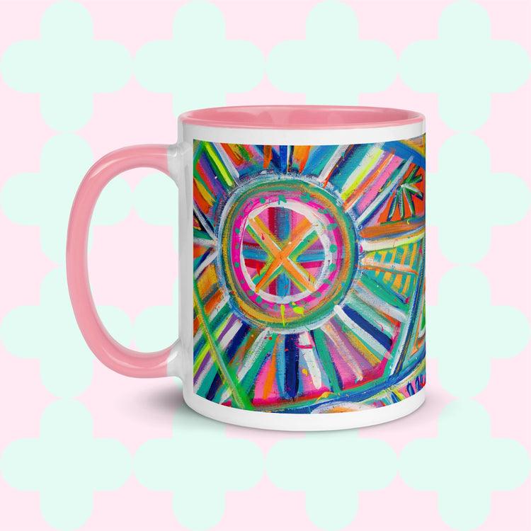 Discover the Geometric Rainbow Mug from My Favourite Colour is Rainbow, featuring a vibrant abstract design of colorful concentric circles and geometric patterns on a pale teal background, complete with a pink handle and interior.