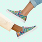 Two individuals showcase their vibrant style with Geometric Rainbow Canvas Sneakers by My Favourite Colour is Rainbow: one in light pants, the other in rolled-up jeans.  The vibrant sneakers feature a colourful abstract design and white soles.