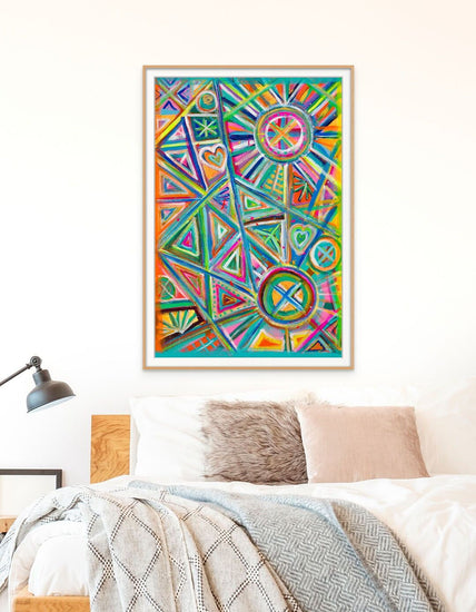 A bedroom with a bed adorned with grey and beige pillows and a textured blanket. Above it, the Geometric Rainbow Fine Art Print by My Store adds flair to the light wall. A black lamp on a bedside table illuminates this artful space, complete with authenticity certification.