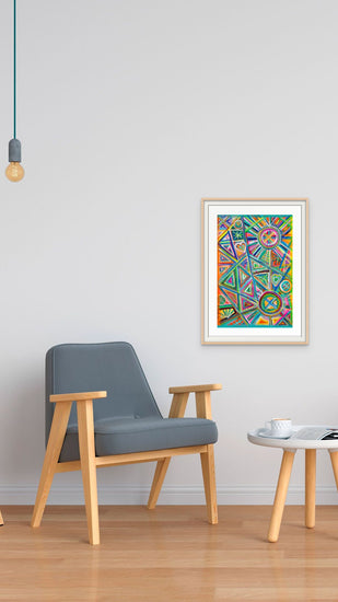 A minimalist room includes a gray armchair and a small round wooden table on hardwood flooring. Geometric Rainbow Fine Art Print by My Store hangs with its authenticity certificate on the white wall. A lone bulb dangles from the ceiling, with a white cup placed on the table.