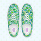 Top view of My Favourite Colour is Rainbows Green Rainbow Canvas Sneakers, featuring a vibrant green, blue, and white abstract pattern. The shoes have white laces and soles, with inner soles labeled GOLF, resting on a light background with subtle star-like designs.