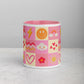 The Happy Smiles Sunny Days Mug by My Favourite Colour is Rainbow is a pink ceramic mug with grid patterns featuring smiley faces, rainbows, hearts, lightning bolts, suns, and flowers. The matching pink interior complements the elegant light gray surface.