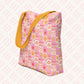 The Happy Smiles Sunny Days Tote Bag by My Favourite Colour is Rainbow features a pattern of suns, hearts, lightning bolts, and clouds on pink. With a spacious interior and yellow strap, its perfect for brightening your day.