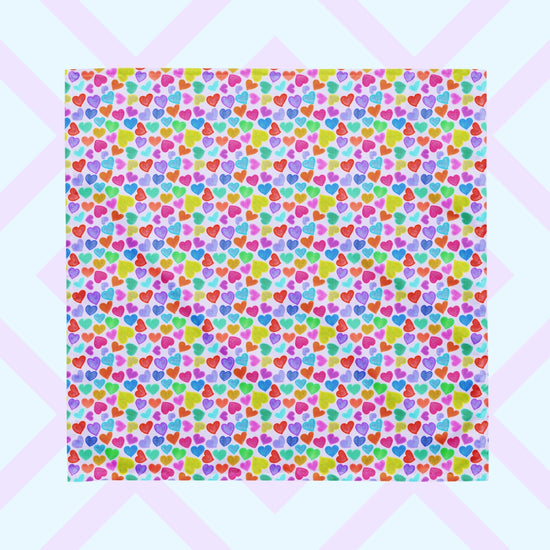 The Heart Attack Bandana by My Favourite Colour is Rainbow features a vibrant, cheerful pattern of densely packed, colourful hearts in pink, blue, purple, green, and orange on a light background. Its versatile and offers UPF50+ protection.