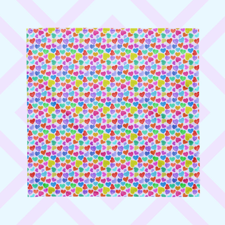 The Heart Attack Bandana by My Favourite Colour is Rainbow features a vibrant, cheerful pattern of densely packed, colourful hearts in pink, blue, purple, green, and orange on a light background. Its versatile and offers UPF50+ protection.