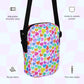 The Heart Attack Mini Crossbody Bag by My Favourite Colour is Rainbow showcases a vibrant Heart Attack print with multicolored hearts. It includes adjustable straps, a two-way zipper, plus inside and outside pockets, crafted from sturdy fabric.