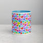 Front view of the Heart Attack Mug by My Favourite Colour is Rainbow, featuring a vibrant heart pattern in red, blue, green, purple, and orange.  It has a sky-blue interior and handle.