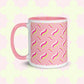 The Iced Vovo Mug by My Favourite Colour is Rainbow features a pink handle on a white and pink base, adorned with wavy lines in pink, yellow, and white against a pink background. 