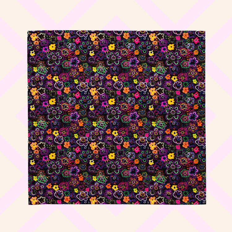 The 'In the Midnight Garden' Bandana by My Favourite Colour is Rainbow features a vibrant floral pattern with pink, orange, yellow, purple, and green flowers on a dark backdrop. 