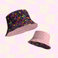 The In the Midnight Garden/Iced Vovo reversible bucket hats from My Favourite Colour is Rainbow feature a black floral pattern with pink abstract shapes and offer versatile flair, perfect for style BFFs.