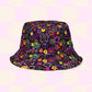 The In the Midnight Garden/Iced Vovo Reversible Bucket Hat by My Favourite Colour is Rainbow features vibrant floral patterns on a dark background. With a pastel pink reverse side and large light yellow circles, its perfect for your Style BFF, available in multiple sizes.