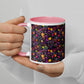 Two hands hold the In the Midnight Garden Mug by My Favourite Colour is Rainbow, featuring a colorful floral pattern with purple, green, yellow, orange, and pink flowers on a black background. The persons nails are painted in a neutral shade.