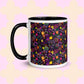 The In the Midnight Garden Mug by My Favourite Colour is Rainbow features a colourful floral pattern of pink, yellow, green, and purple hand-drawn flowers on a black background. It has a black handle and interior.