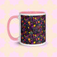 The In the Midnight Garden Mug by My Favourite Colour is Rainbow features a colourful floral pattern of pink, yellow, green, and purple hand-drawn flowers on a black background. It has a light pink handle and interior.