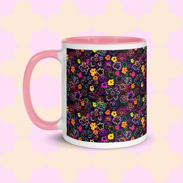 The In the Midnight Garden Mug by My Favourite Colour is Rainbow features a colourful floral pattern of pink, yellow, green, and purple hand-drawn flowers on a black background. It has a light pink handle and interior.