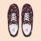 A top-view shot of the In the Midnight Garden Canvas Sneakers by My Favourite Colour is Rainbow reveals a vibrant floral pattern in pink, yellow, red, and green on a black background. They feature white laces and sole, breathable lining, and a logo-branded insole.