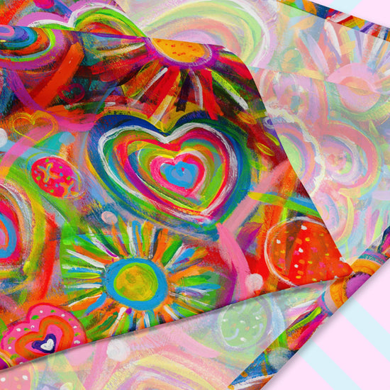 The Love in Neon Bandana by My Favourite Colour is Rainbow is a vibrant abstract piece with colorful hearts, suns, and swirls in red, pink, green, and blue. It mirrors the versatility of bandanas as dynamic accessories offering style and UPF50+ protection in a lively composition.