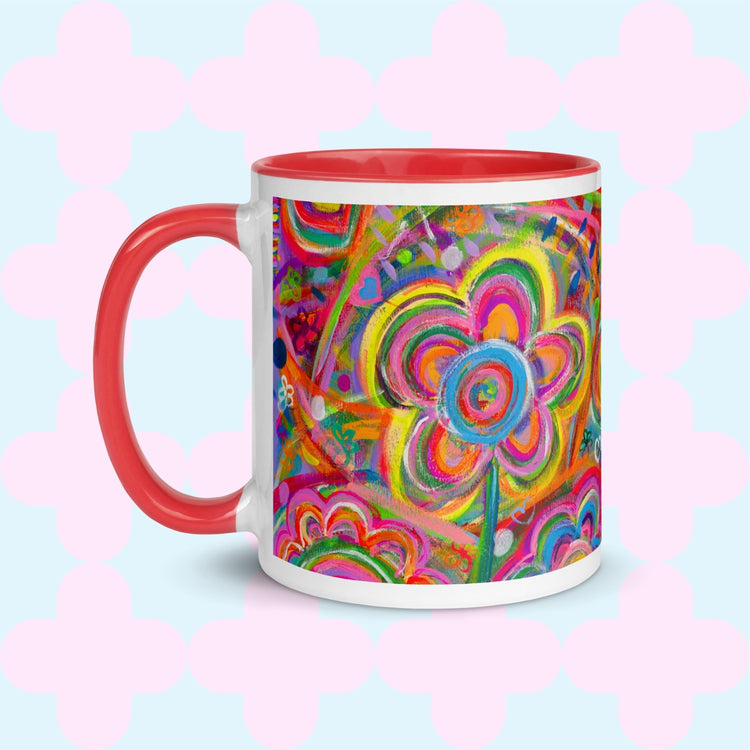 The Love in Neon Mug by My Favourite Colour is Rainbow features my Love in Neon painting with bold floral and heart patterns in vibrant pink, yellow, blue, and green. It has a red handle and interior.