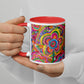 A person holds the Love in Neon Mug by My Favourite Colour is Rainbow, showcasing a red interior and vibrant abstract flowers and swirls. They're wearing a white shirt, and their nails are painted light taupe.