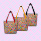 Three Love in Neon Tote Bags by My Favourite Colour is Rainbow hang from hooks.  They feature my Love in Neon painting, with vibrant heart and abstract flower designs.