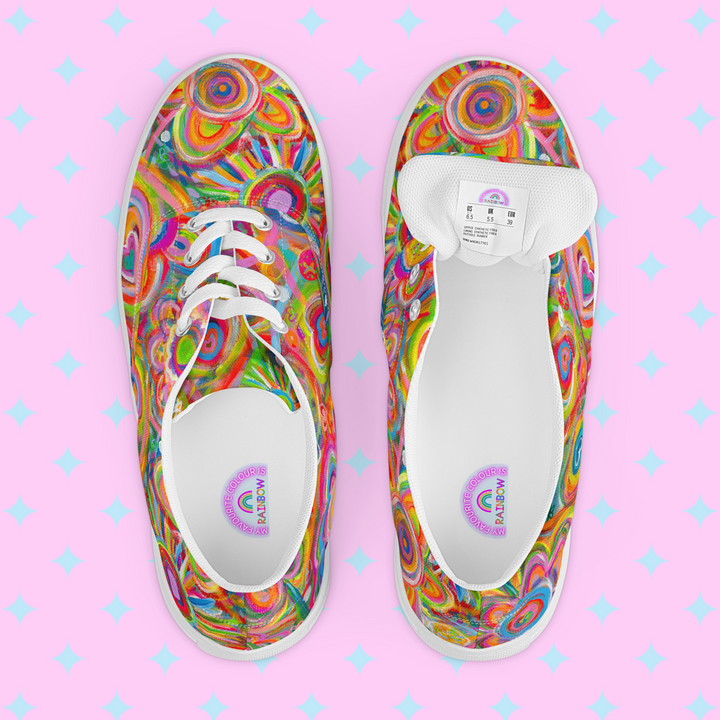 The Love in Neon Canvas Sneakers by My Favourite Colour is Rainbow are showcased against a pink starry background, displaying one shoes side view and the others top view, with the label inside visible.