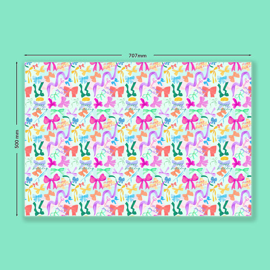 The Multicolour Bow Birthday Wrapping Paper Sheets by My Favourite Colour is Rainbow features bows, ribbons, and Happy Birthday in pink, orange, green, and blue on a light green background. The image measures 707mm by 500mm and is set against a turquoise backdrop.