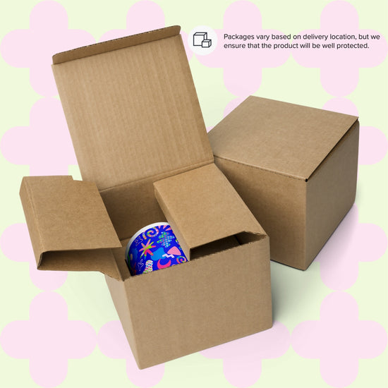 Two brown cardboard boxes.  One is open with a Neon Carnival Mug. The other is closed.  Text: Packages vary based on delivery location but we ensure your mug will be well protected.