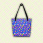 The Neon Carnival Tote Bag by My Favourite Colour is Rainbow with black handles, hangs from a hook. This spacious and colourful tote boasts a vibrant pattern of abstract shapes in blue, green, pink and white.