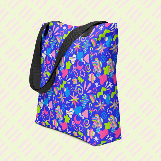 The Neon Carnival Tote Bag by My Favourite Colour is Rainbow is a spacious and colourful tote bag which boasts a vibrant pattern of abstract shapes in blue, green, pink and white.  It has sturdy black handles.