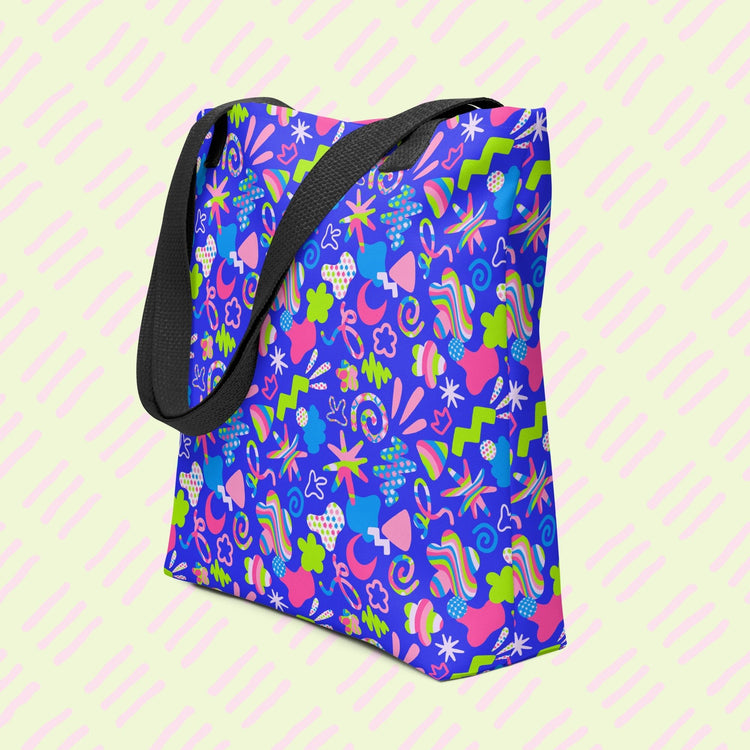 The Neon Carnival Tote Bag by My Favourite Colour is Rainbow is a spacious and colourful tote bag which boasts a vibrant pattern of abstract shapes in blue, green, pink and white.  It has sturdy black handles.