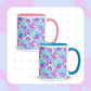 Two Pastel Rainbow Mugs by My Favourite Colour is Rainbow, featuring soft watercolour rainbows in pink, blue, aqua and white.  One features a pink handle and interior, and the other has blue. 