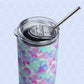 The Pastel Rainbow Stainless Steel Tumbler by My Favourite Colour is Rainbow showcases a pattern of pink, blue, and green brush strokes with a metal straw against a light blue hexagonal background.