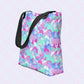 The Pastel Rainbow Tote Bag by My Favourite Colour is Rainbow features watercolour pastel rainbows in shades of blue, purple, pink, and teal.  It has sturdy black handles.