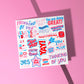 The Pep Talk Greeting Card by My Favourite Colour is Rainbow features a vibrant collage of motivational phrases like You Got This, Dream Big, and Keep Going in lively red, blue, and pink fonts on a white background.  Shown on a pink background.