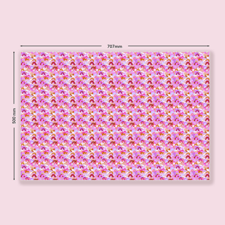 The Pink Rainbow Wrapping Paper Sheets by My Favourite Colour is Rainbow are rectangular, features an abstract pattern  of watercolour brushstrokes resembling rainbows in shades of pink. Dimensions: 707mm wide and 500mm tall.