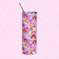 A Pink Rainbow Stainless Steel Tumbler from My Favourite Colour is Rainbow, featuring a vibrant abstract design in pink, orange, and purple shades with a metal straw, rests on a pink hexagonal patterned background.