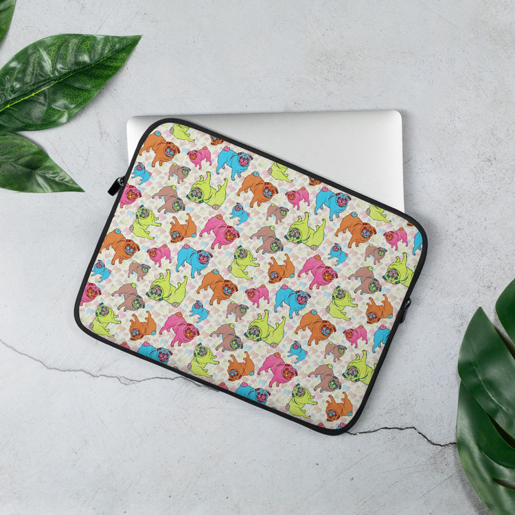 The 13 inch Pugalicious Laptop Sleeve by My Favourite Colour is Rainbow, partially open and revealing a silver laptop. 
 The design features playful cartoon pugs in vibrant green, blue, pink, and brown. The sleeve is on a light grey surface with large green leaves.