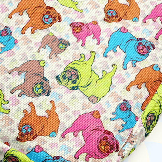 The Pugalicious Mini Crossbody Bag by My Favourite Colour is Rainbow features a colorful pattern of cartoon-style pugs in green, pink, and blue on a textured background, crafted from sturdy water-resistant fabric with adjustable straps.