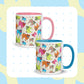 Two Pugalicious Mugs by My Favourite Colour is Rainbow captivate pug lovers with vibrant pink and blue handles and playful multicoloured pug illustrations.  The mugs are shown on a white background with small blue crosses and an abstract pastel design.