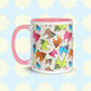 The Pugalicious Mug by My Favourite Colour is Rainbow delights pug lovers with colourful pug illustrations in orange, pink, green, blue, and brown. This version has a light pink handle and interior.