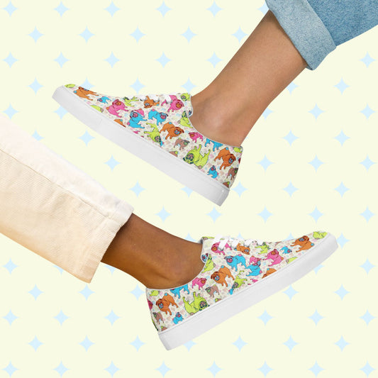 Two people in mirrored poses wear lively Pugalicious Canvas Sneakers by My Favourite Colour is Rainbow. The background features a light diamond pattern. One pairs them with light beige pants, the other with rolled-up light blue jeans, perfectly complementing their womens canvas shoes.