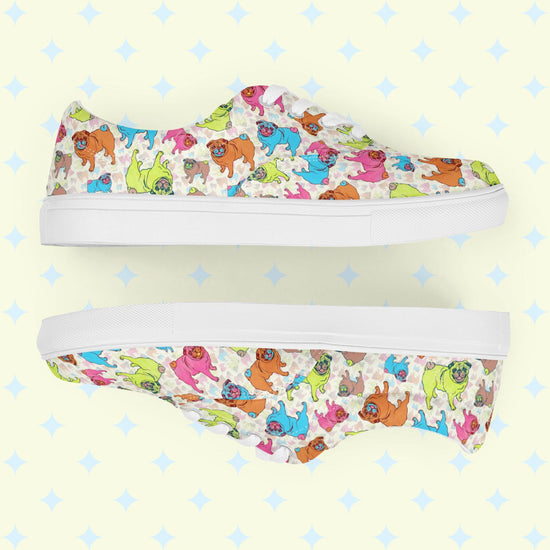 The Pugalicious Canvas Sneakers by My Favourite Colour is Rainbow boast a playful design with colorful cartoon-style pugs in pink, green, blue, and orange on a pale yellow background with star patterns. These lace-ups offer breathable lining for all-day comfort while adding flair to your outfit.