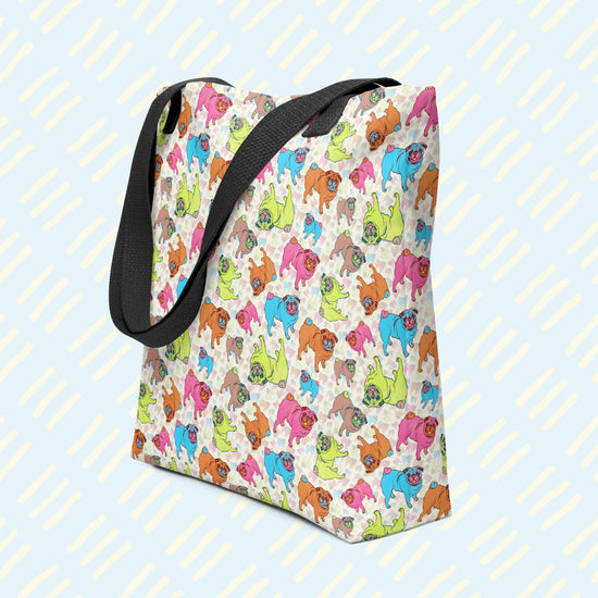 The Pugalicious Tote Bag by My Favourite Colour is Rainbow features a cartoon pug pattern in vibrant blue, pink, green, and orange. It has sturdy black straps.