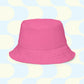 The Pugalicious Reversible Bucket Hat by My Favourite Colour is Rainbow is showcased against a retro backdrop featuring light blue and cream geometric shapes, capturing the essence of streetwear chic.