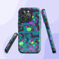 The Silly Sausages MagSafe iPhone Case by My Favourite Colour is Rainbow features a playful dachshund pattern in colorful sweaters on teal. This dual-layer case, with pink, purple, green, and blue accents, supports wireless charging and displays the design on its sides and back.