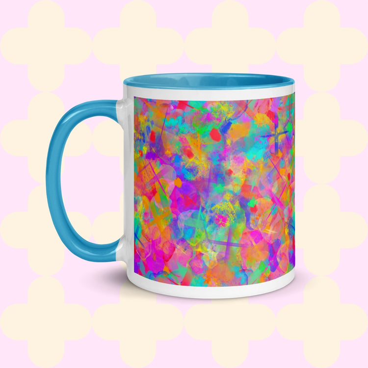 The Splotches and Crosses Mug by My Favourite Colour is Rainbow is a white mug with a light blue interior and handle, featuring a vibrant abstract design with splashes of green, blue, pink, and orange. 