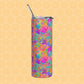 The Splotches and Crosses Stainless Steel Tumbler by My Favourite Colour is Rainbow, featuring a vibrant abstract design with splashes of pink, blue, yellow, orange, and green, rests on a honeycomb-patterned background with its matching metal straw.