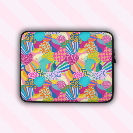 The Squiggs and Stripes Laptop Sleeve by My Favourite Colour is Rainbow features an abstract design of colourful geometric shapes, stripes and squiggles in pink, blue, orange yellow, and green.  It is shown on a pastel background.  The print is on only one side of the laptop sleeve, the other side is black.