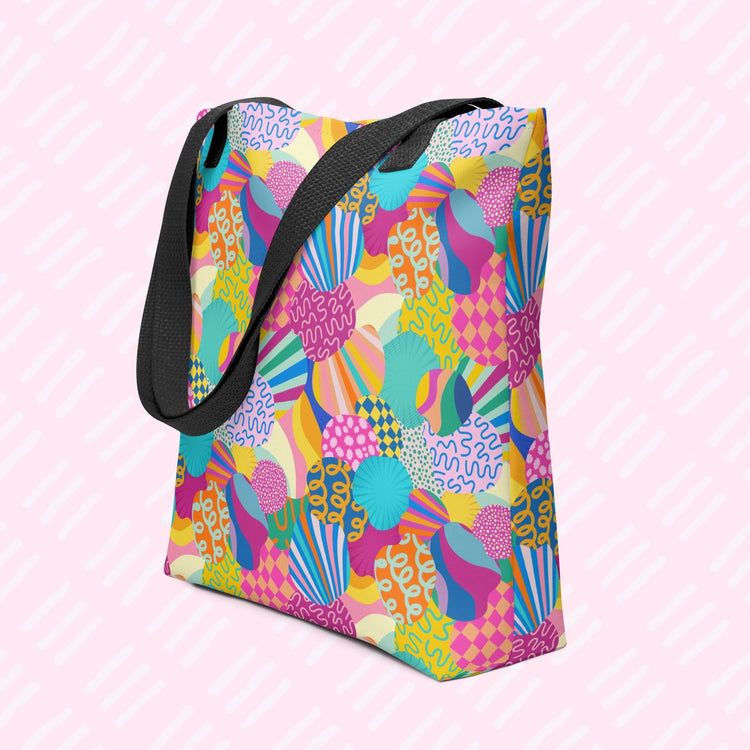 The Squiggs and Stripes Tote Bag by My Favourite Colour is Rainbow featuring vibrant abstract patterns—shells, waves, arches—in blue, pink, yellow, and green. This one has yellow handles.